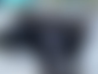 two gray tabby cats sleeping on a white cat bed, snuggled together