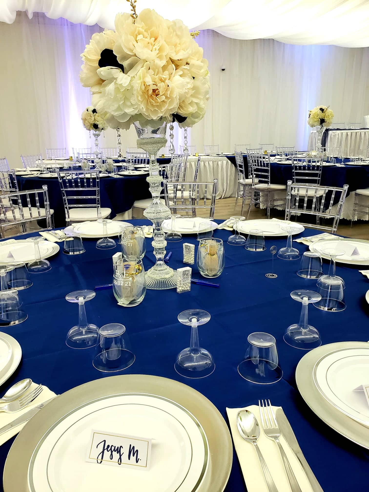 Dark blue table with white rose centerpiece on vase