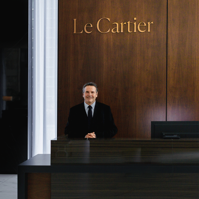 Concierge at the counter of Le Cartier luxurious rental apartments.