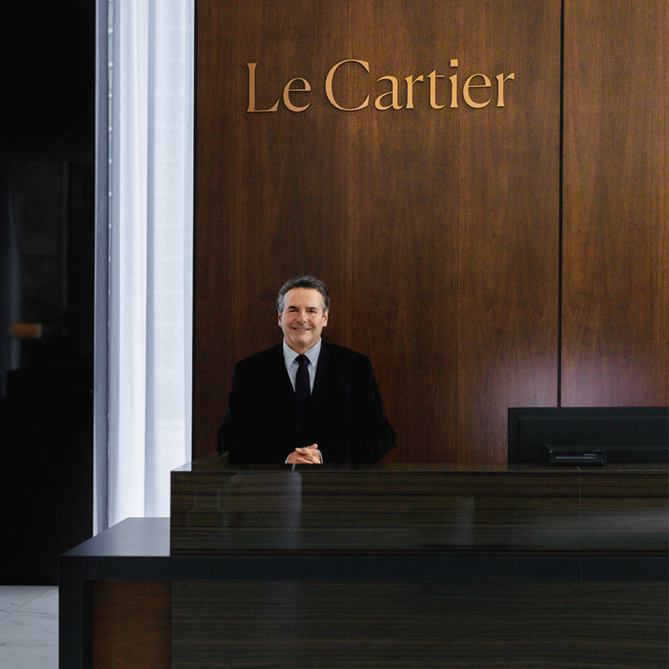 Concierge at the counter of Le Cartier luxurious rental apartments.