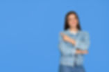 Happy cute Latin teenage student girl pointing aside standing on background. Smiling prett