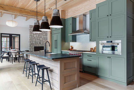 Modern industrial kitchen renovation with built-in cabinetry and custom kitchen island with dining seating