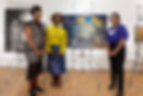 image of 3 women posing in front of a painting