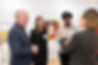image of man speaking to women at event