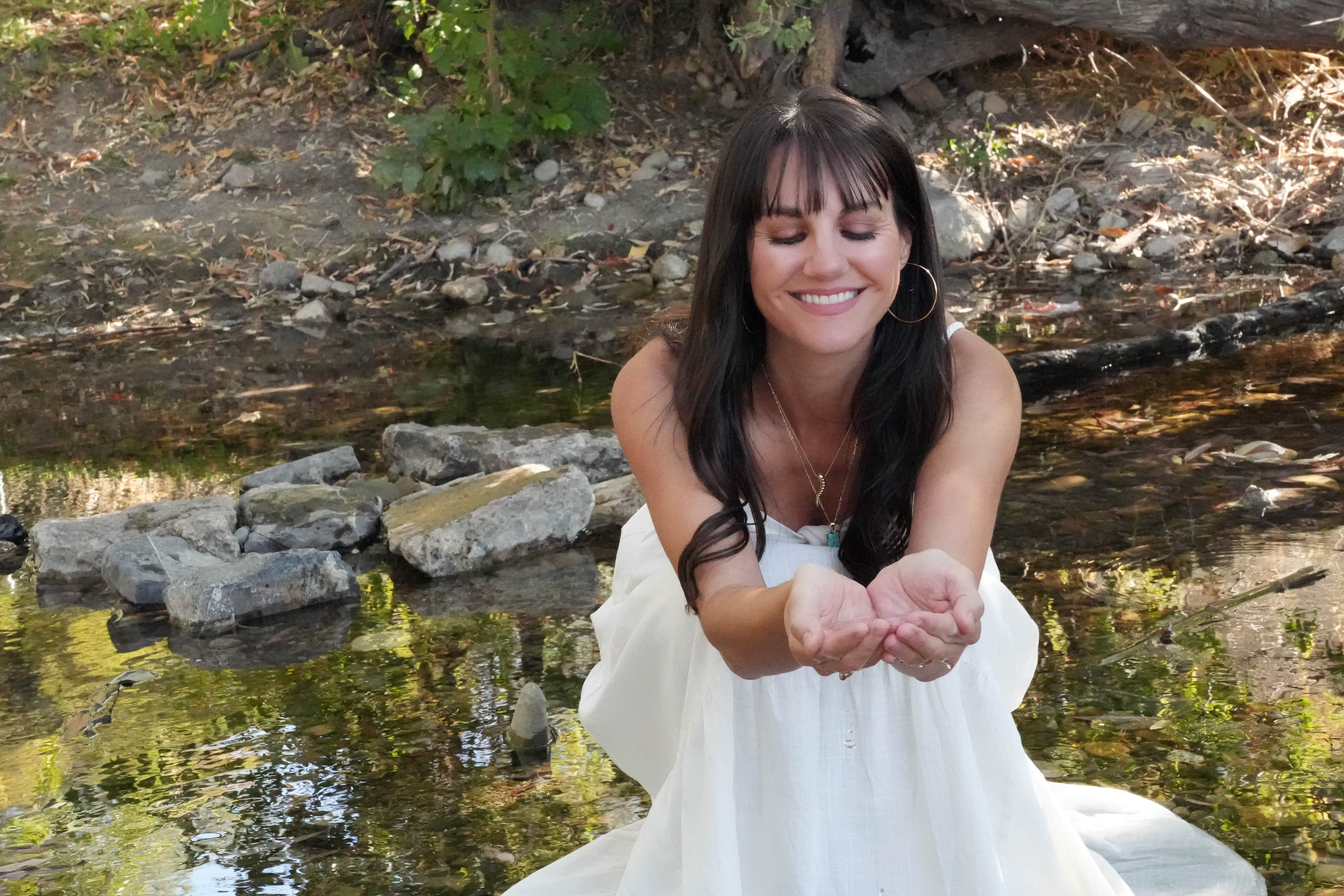 Tresa Rivera sitting in the branches of a willow tree