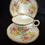 Miniatura: Royal Stafford ‘Lily’. Trio. Tea cup, saucer & plate