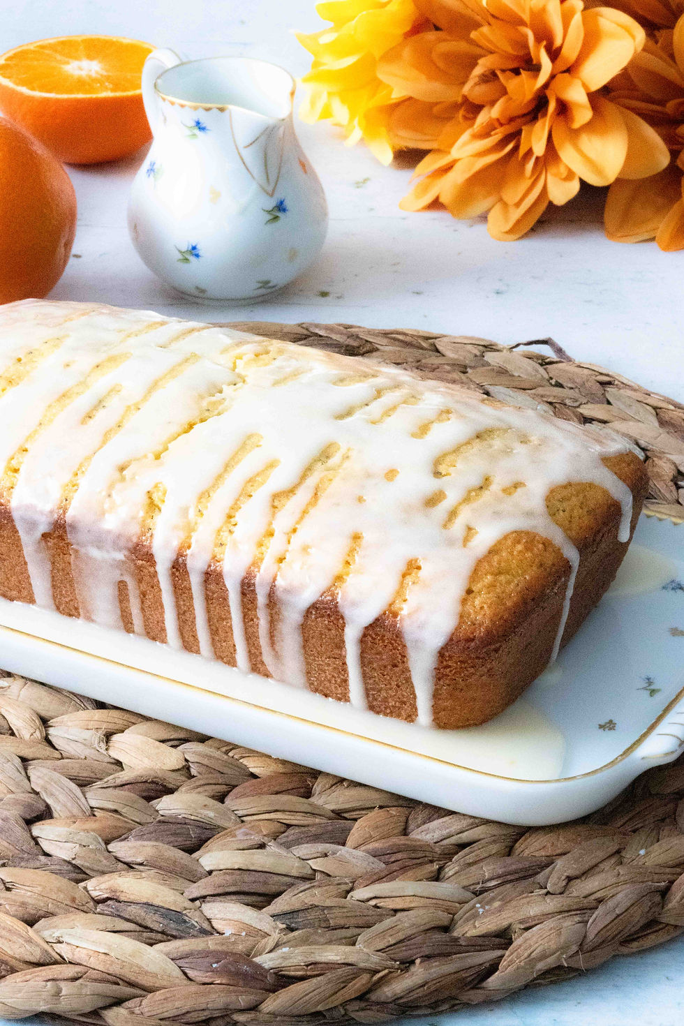 Orange poppy seed loaf with a white glaze drizzled overtop.