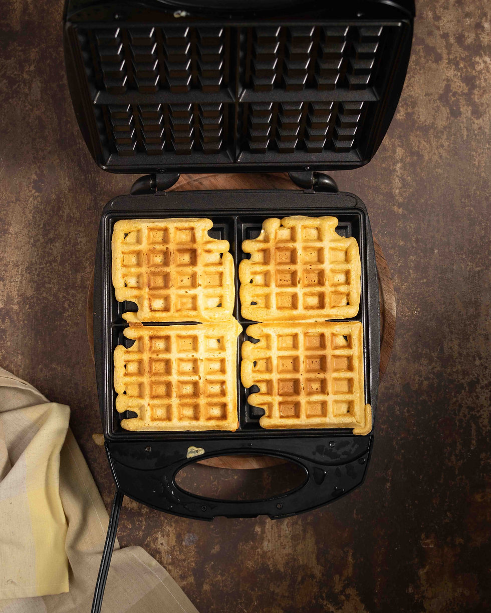 Cooked waffles in a waffle iron.