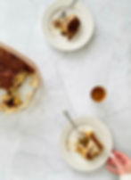 Tiramisu being served on a white background