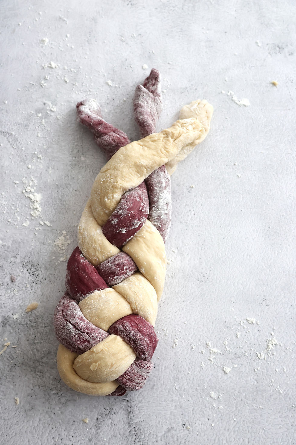 Dough braided into a multicolored loaf.