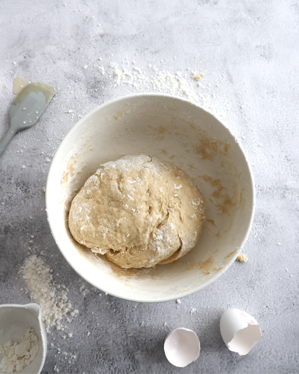Mixed dough in a bowl set aside to rise.