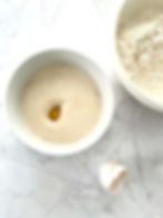 Adding the butter and egg to the yeast mixture.