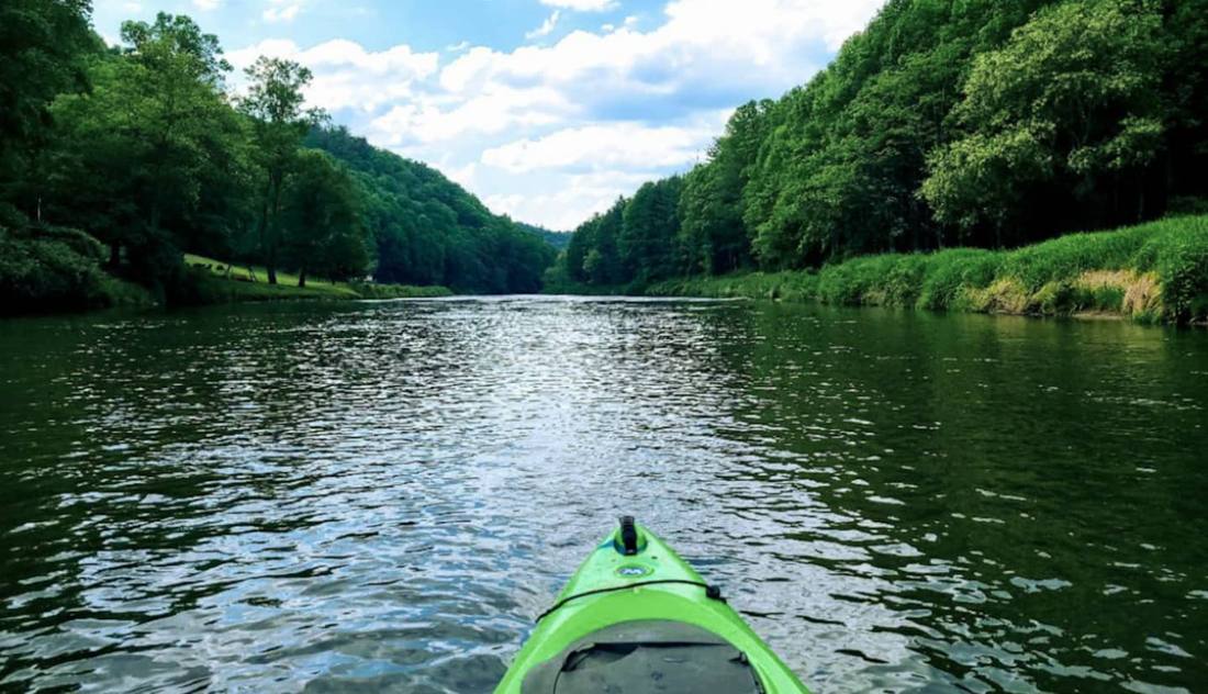A canoe on calm water on the New River
