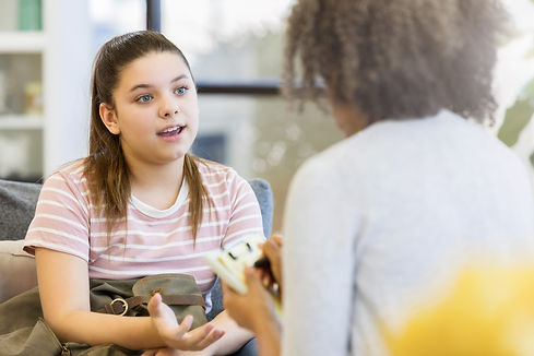 A teenage girl talking to her support mentor in a home setting