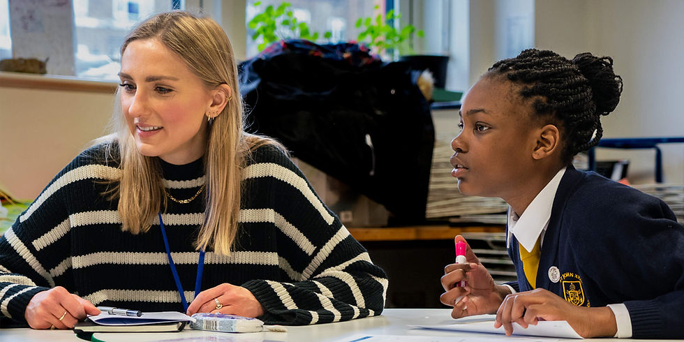 A female student engaged in conversation with a female mentor