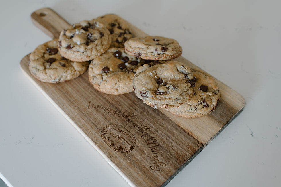 Fresh chocolate chip cookies on a wooden board