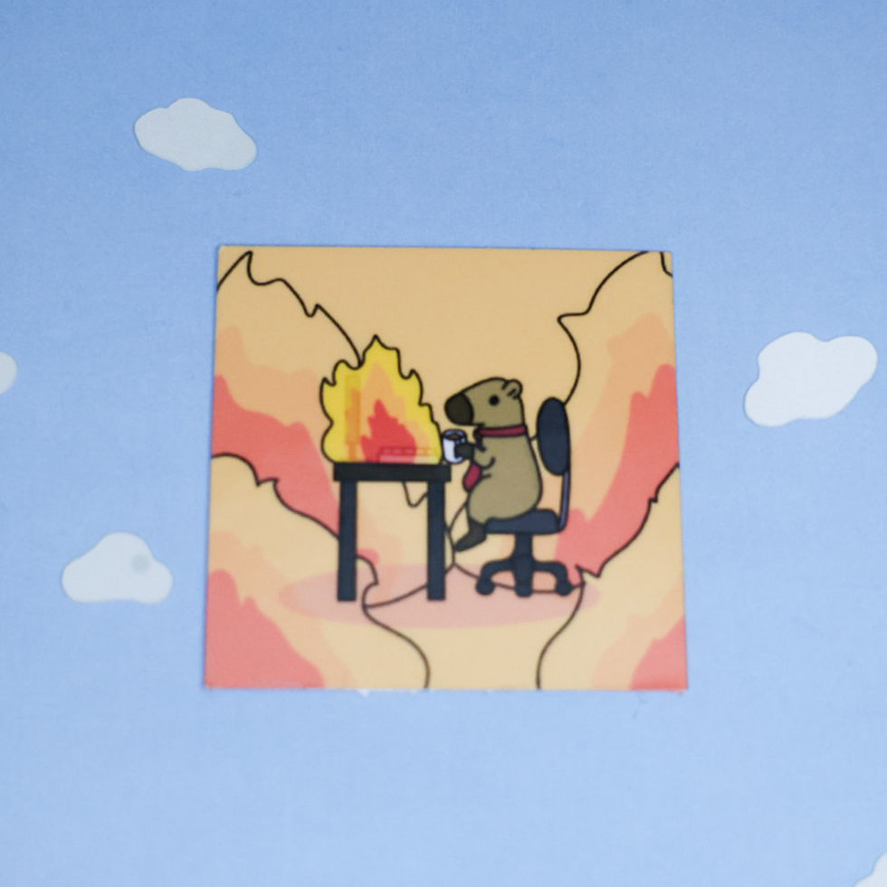 A business capybara sitting at a desk with the computer in flames along with the background.