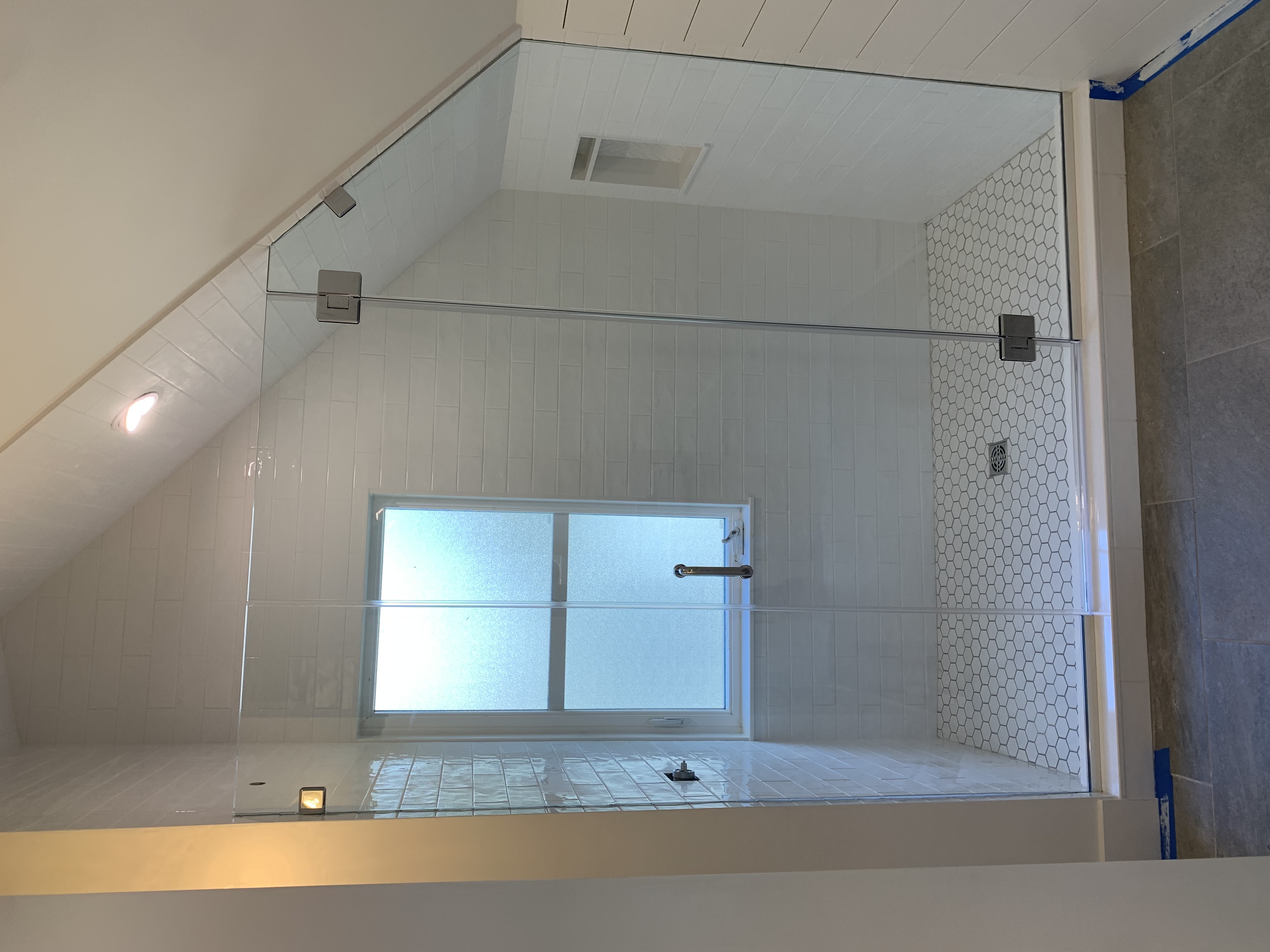 Shower glass panel and hardware detail