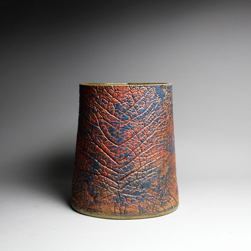 Thumbnail: Ceramic vessel from the Malham Range. Warm, earthy Reds, Oranges and blue tones . Rear view.