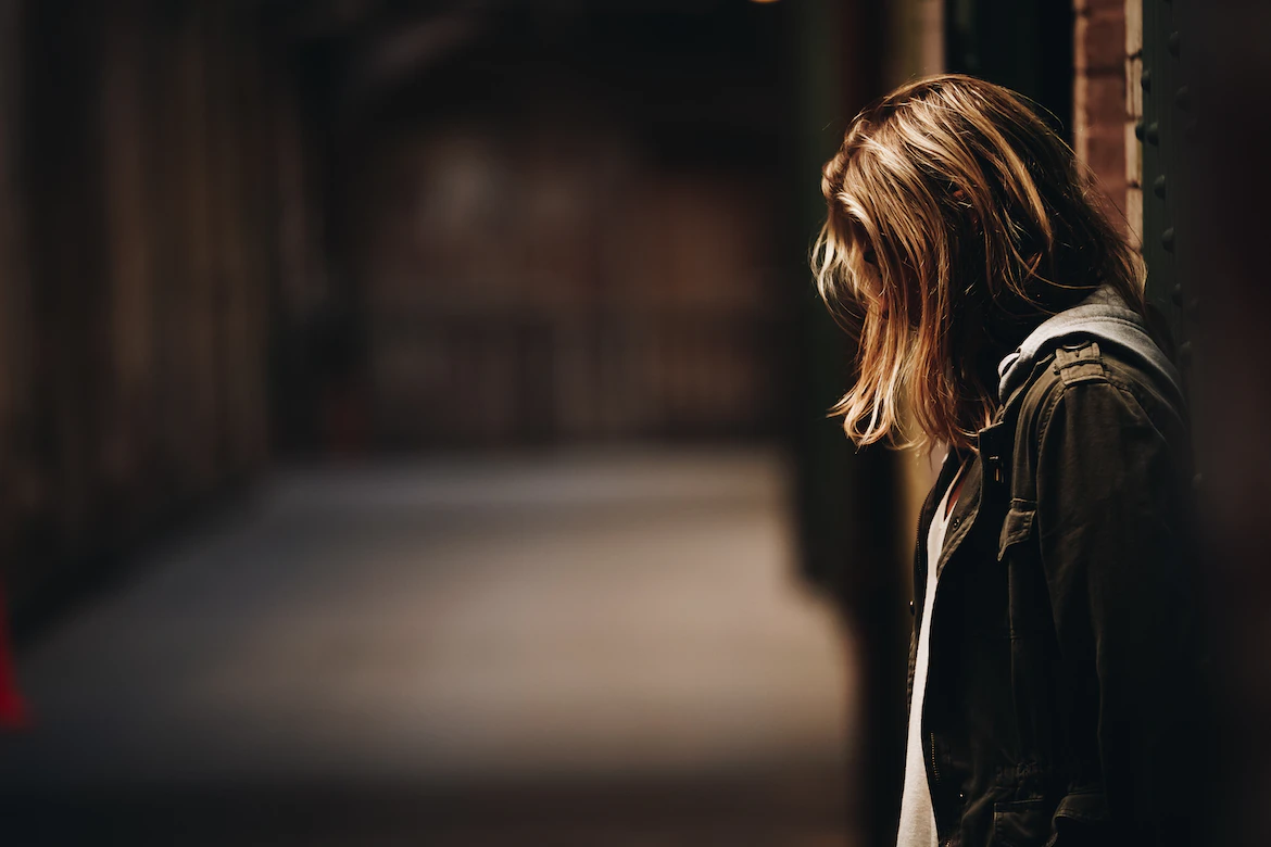 woman on dark street in mental health therapy