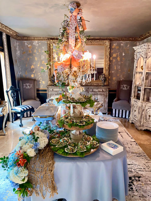 Catering table setup with food and floral decorations