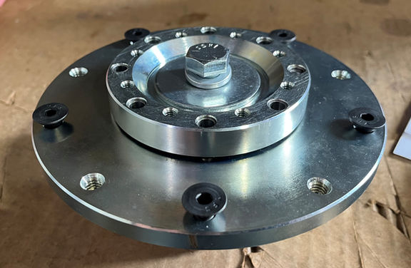 Circular metal mechanical component with bolts and flanges