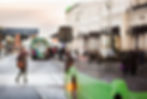 woman-walking-by-a-green-bus-in-the-city-at-dusk-2025-04-03-05-09-47-utc (1).jpg