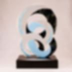 Modern sculpture of intersecting loops of baby blue, clear glass to engage its environment and black highlights.