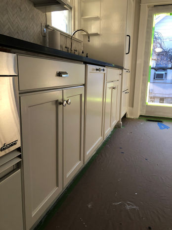 Stained oak cabinets updated with a flawless spray finish, Benjamin Moore scuff-x  semi gloss. Chantilly Lace