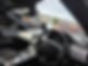 The car interior showcases a sleek black steering wheel and dashboard, with a newly installed windscreen