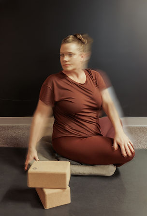 Yoga specialist offering somatic awareness support in a trauma-informed session