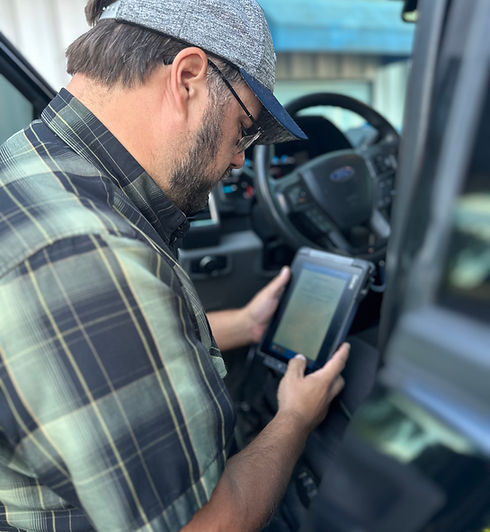 Turner CTC Testing technician performing an on-site Clean Truck Check emissions test on a semi-truck