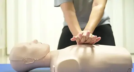 Nursing student performing chest compressions during an American Heart Association CPR certification class at CPR Buddy in St. Petersburg, Florida.