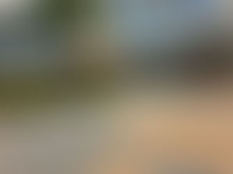 A sleek hospital exterior with a curved glass facade, palm trees, and landscaped greenery, featuring clear signage for “Main Entrance” and “EMERGENCY.” This image highlights the availability of 24/7 mobile notary and Certified Trust Delivery Agent services across Florida medical facilities—supporting urgent legal documentation needs such as power of attorney, advance directives, and estate planning in healthcare settings.