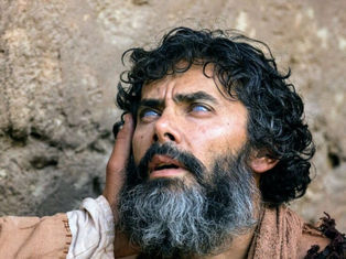 A blind man receives eyesight from Jesus