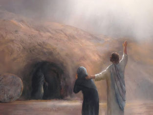A figure in white comforts a person in black before a cave entrance, with a rolled stone nearby. Soft light shines from above, creating a serene mood.