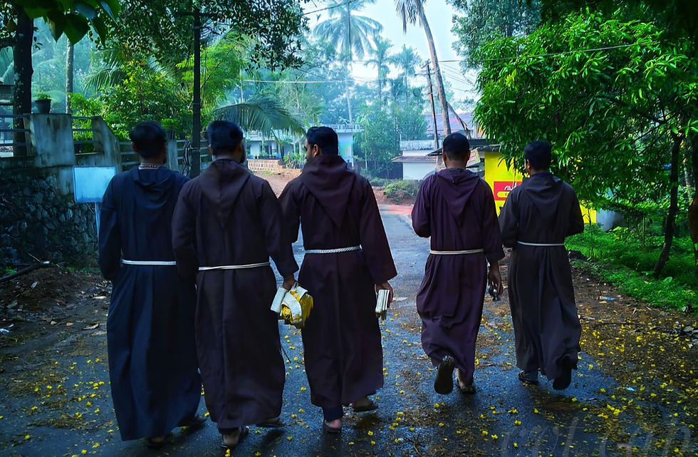 A few Capuchin Friars in brown habit, walking along the road
