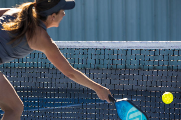 resident playing pickle ball at Wolf Creek Chapel Hill community courts