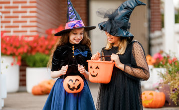 children dressed for Halloween outside their home in Wolf Creek Chapel Hill