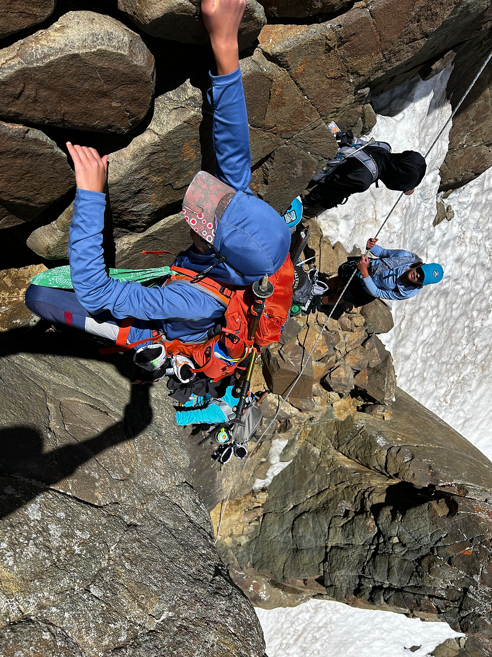 Climber hanging onto rock wall