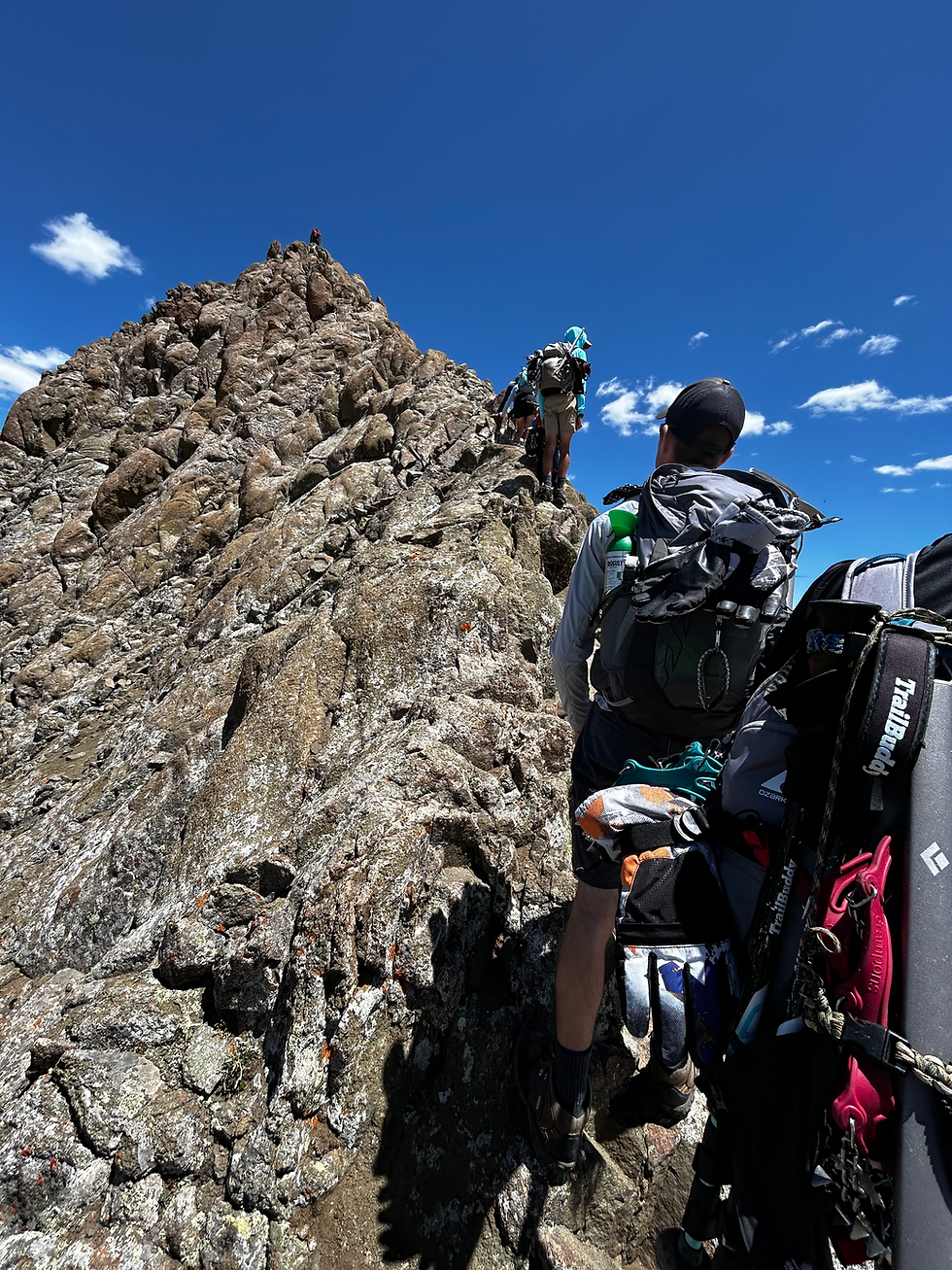 Hikers on narrow rocky ridge