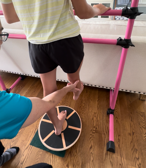Hope OnBoard therapist assisting a patient with balance training during a home-based therapy session.