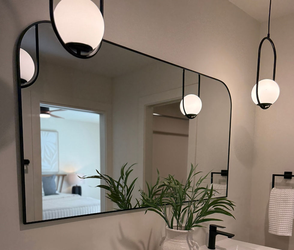 Bathroom mirror with modern pendant lighting and soft reflections in a Phoenix interior renovation by Pediment and Pillar Design