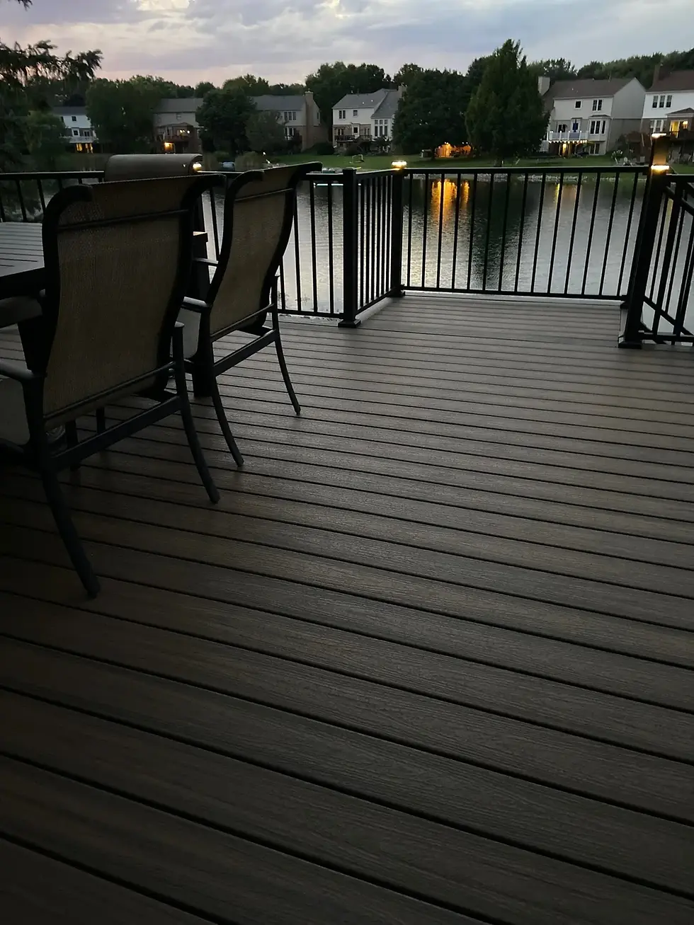Renovated Deck in the Sunset by a small lake in Michigan with a table and chairs