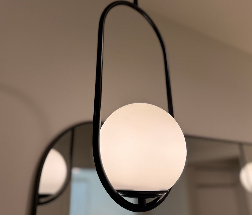 Close-up of modern pendant lighting with soft glow and minimal form in a refined Arizona interior