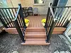 Small Custom Deck with Black Deck Raililng and 2 yellow plants