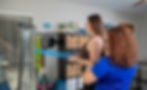 Craniofacial physical therapy session using resistance bands for posture, neck, and upper body support in Gainesville FL.