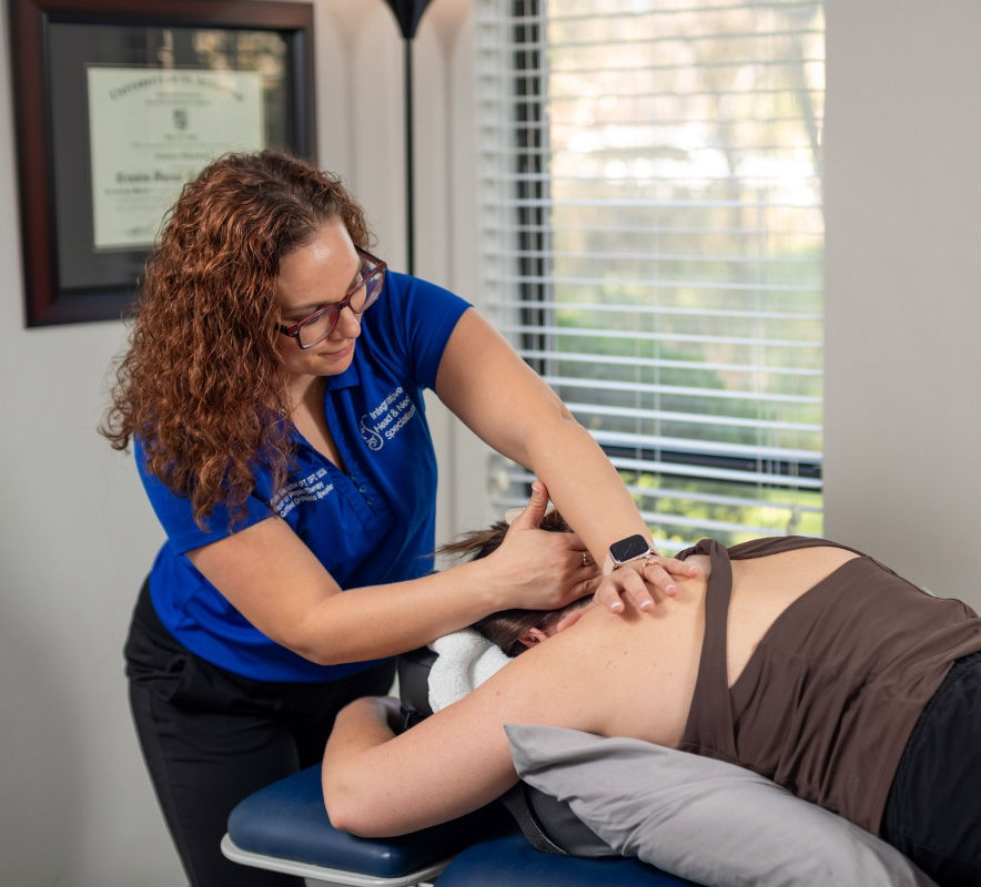 Dr. Erienne Blanchard providing hands-on manual therapy for neck pain in Gainesville FL.
