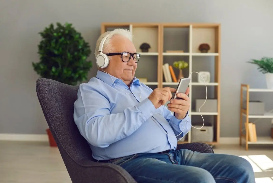Happy Elder using a phone.webp