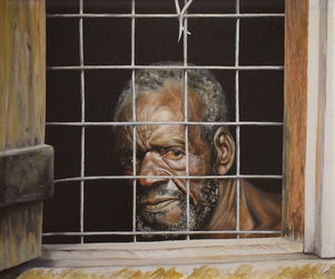 Portrait of an old black man behind a wire mesh